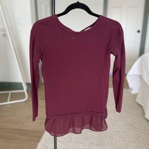 Maroon blouse with chiffon waist detail.